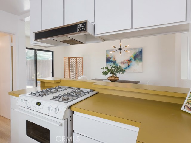 Kitchen looking over to dining area and backyard entrance.
