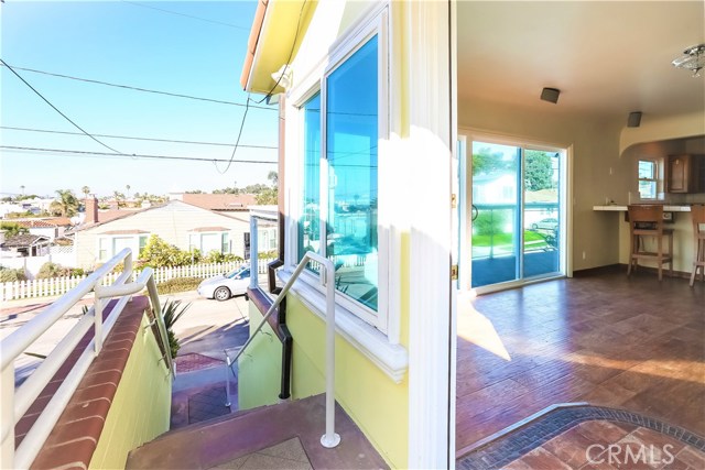 The living room has a bright open interior surrounded by windows and decks.