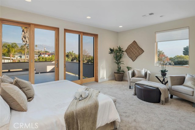 master bedroom with ocean views and ocean view roof top deck