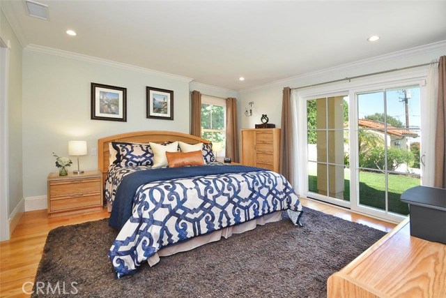 New Downstairs Master Bedroom with view of the lushly landscaped backyard