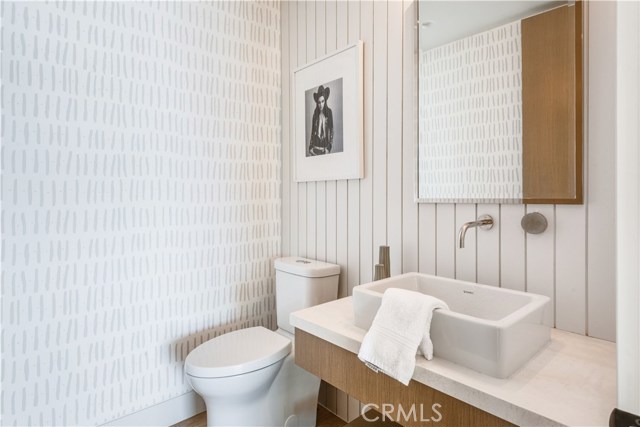 This 1/2 bath with chic styling services the common area