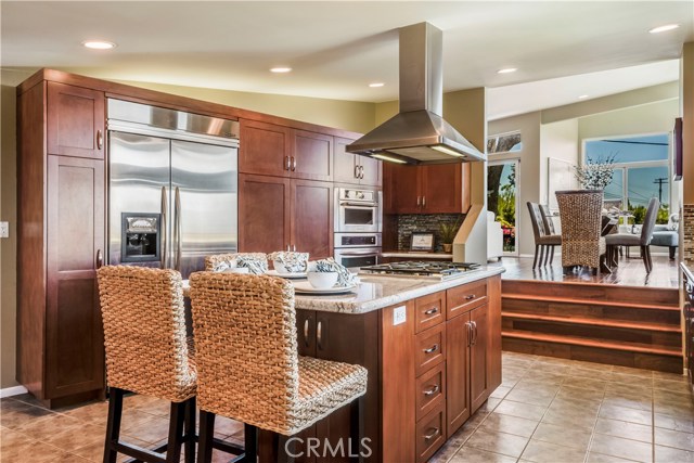 large gourmet kitchen with center island and stainless steel appliances