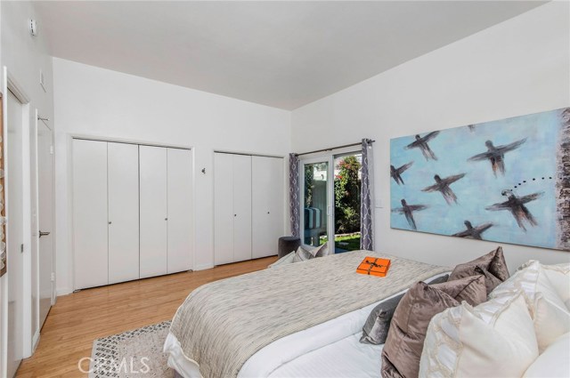 The first floor bedroom is spacious with closet space and access to the bath and the grassy backyard on this floor.
