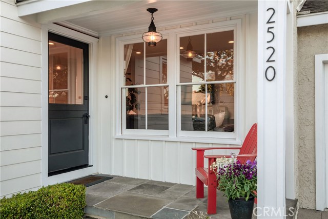 The welcoming front porch greets you, overlooking the front yard and neighborhood...