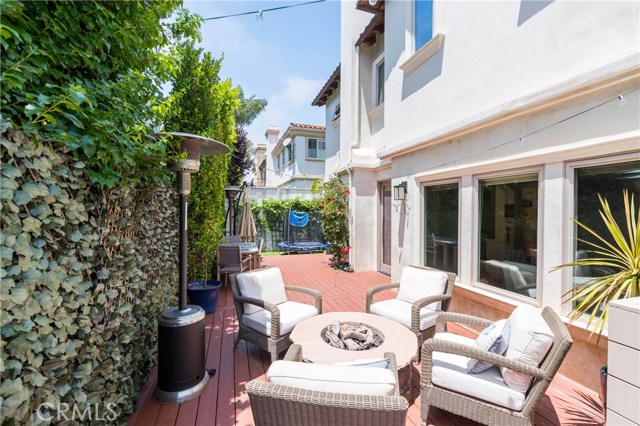 Another view of the deck with artificial grass yard beyond.  Such a terrific space.