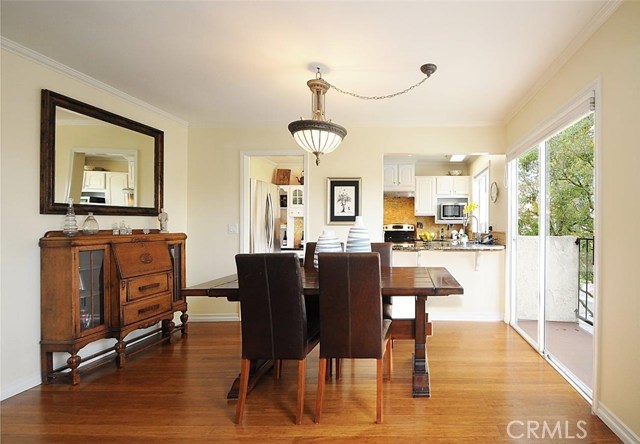 Dining Room with balcony and view into Kitchen.