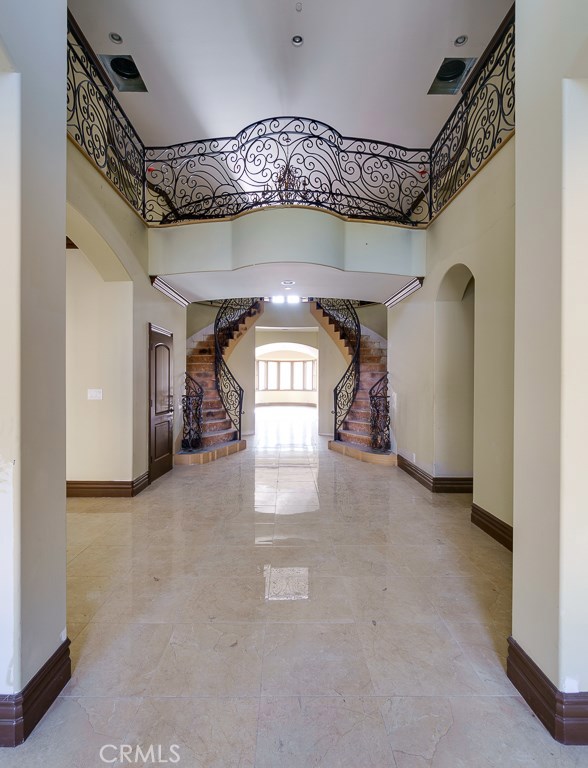 Grand entrance features elaborate wrought iron railings.