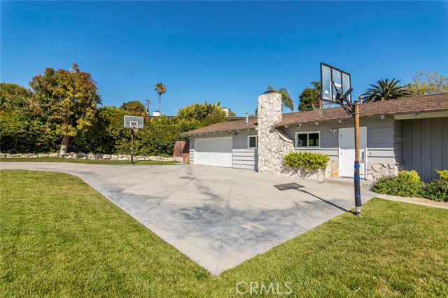 The long driveway leading to the two-car garage with additional parking can suit you and your guests.