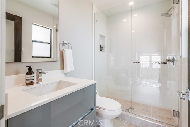 Sophisticated bath on mezzanine level with frameless shower