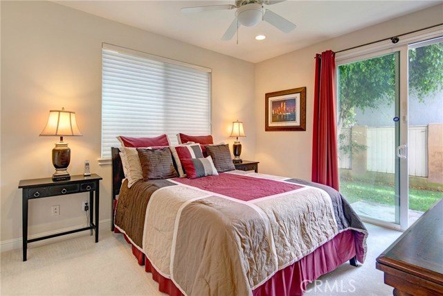 Downstairs bedroom #2 with ceiling fan, recessed lights, and access to backyard.