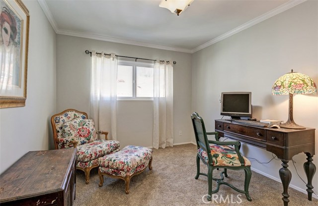 2nd bedroom with carpet and crown molding.