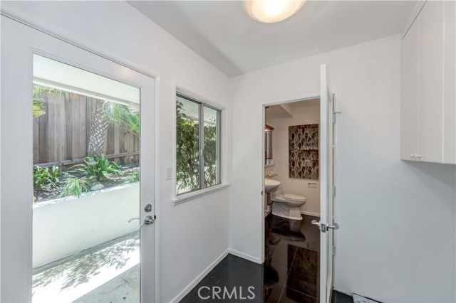 Laundry room, door to sideway, bathroom with sauna.