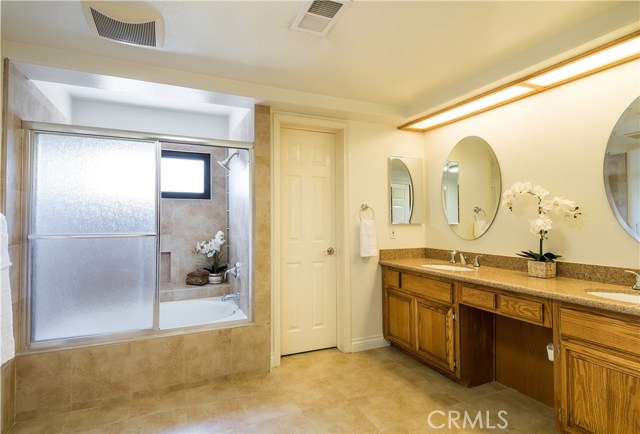 Upgraded Master Bath with new counter tops, shower doors, mirrors over vanity.  Dual sinks, private commode, walk-in closet.