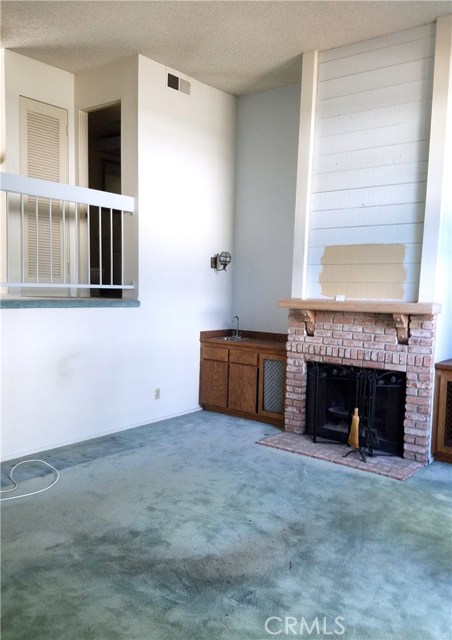 Living room, Fireplace & wet bar sink.