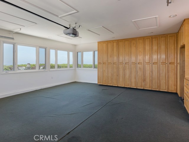 Detached garage has custom cabinets for storage, newer window, amazing ocean views. Great place to make a home gym or office space.