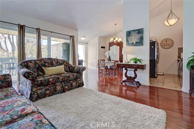 Living room with sunlight pouring through the sliding glass doors on the deck.