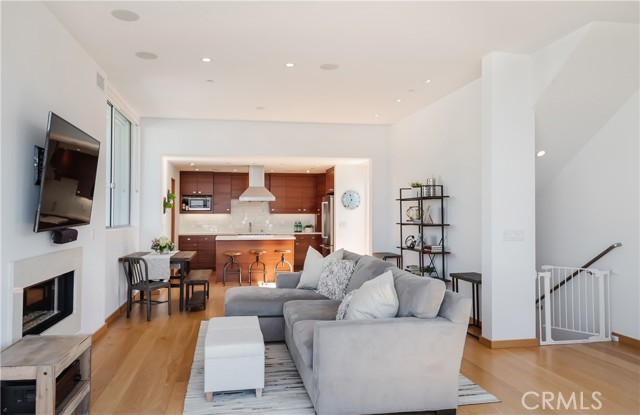 Gourmet kitchen with quartz counter tops opens to the living room, then onto the spacious deck with ocean view