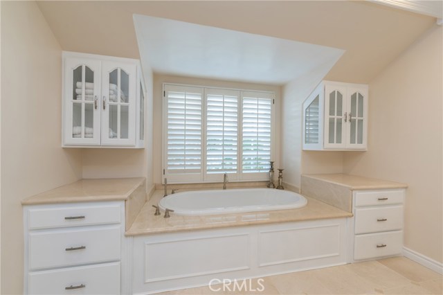 Luxurious new soaking tub, and tons of built in storage surrounding it!