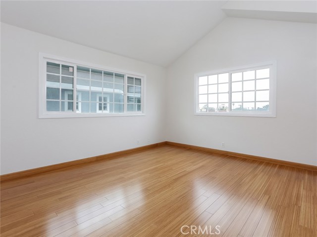 Second master with bamboo flooring and vaulted ceiling