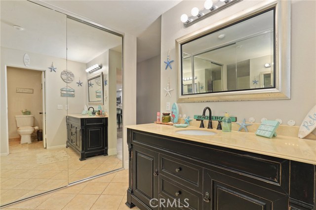 His and Hers closets situated behind glass doors in the Master bathroom.