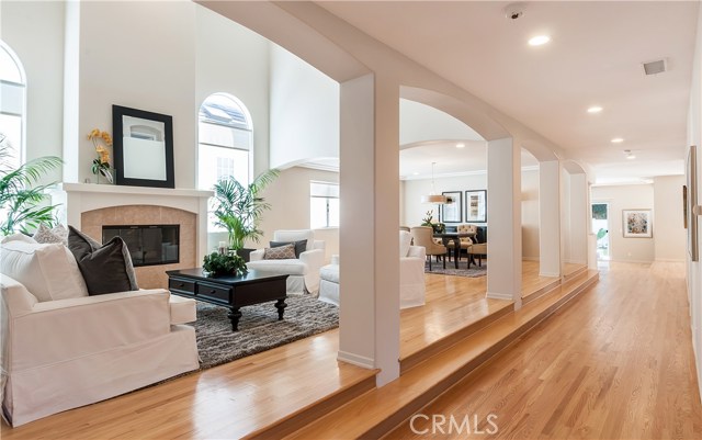 View of central hallway and living with two story high volume ceilings