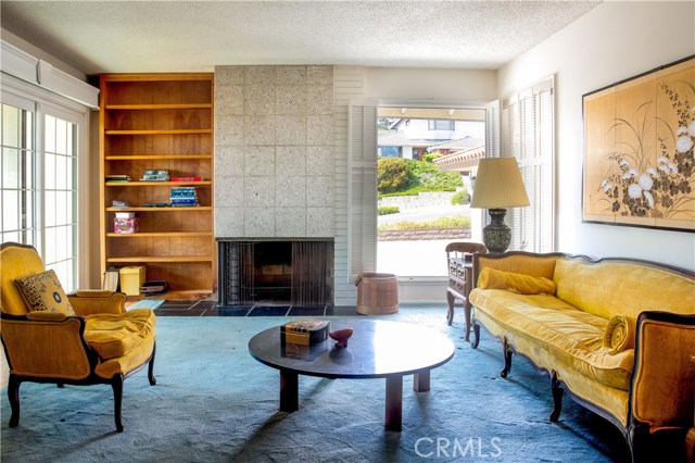 Formal living room with fireplace and a view from porch on West side