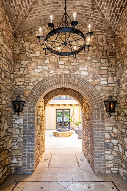 Impressive 2 story tall Gas lamp entrance with brick coved ceiling