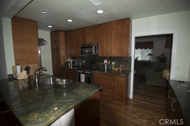 View of kitchen / cabinetry from family room area.