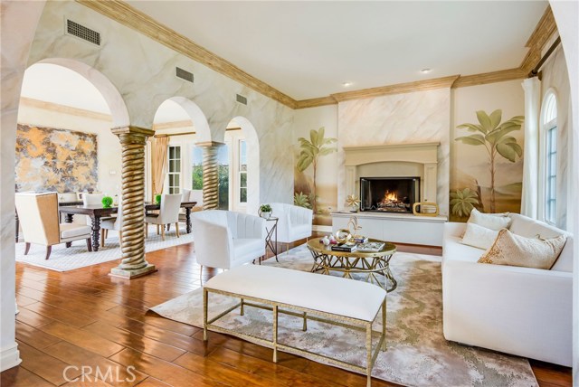 Formal living room near the front door, and partial view of the dining room with French doors on both sides of the table.