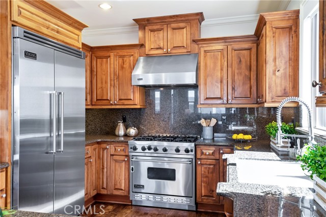 Beautiful kitchen with gleaming cabinetry, hardwood floors, Viking appliances and granite counters