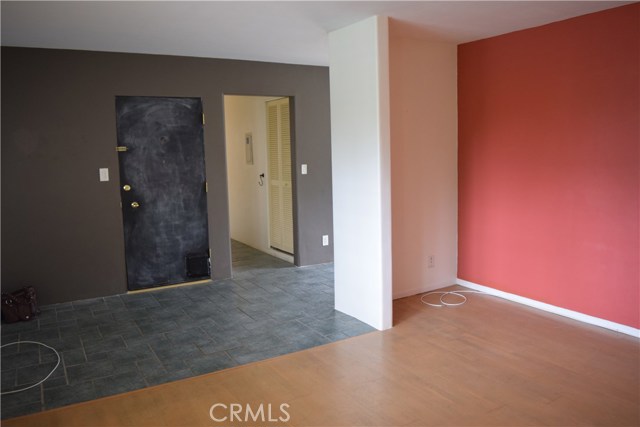 Living room with TV niche to entry way and the front door with chalk paint for your creative touch!