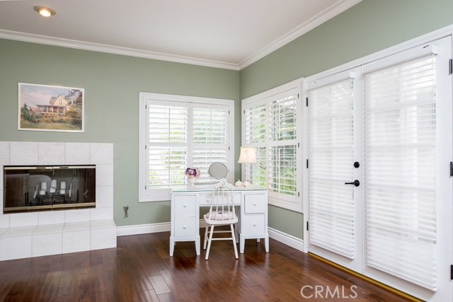 Master bedroom with fireplace and doors to patio outside