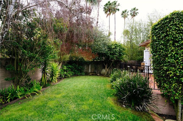 The private and grassy backyard of 106 Coronel Plaza is a tranquil retreat.