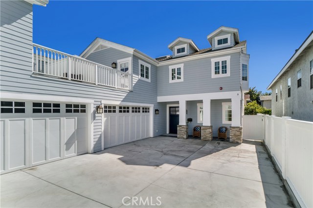 One-of-a-kind custom Cape Cod townhome with so much space for kids to play in the driveway.