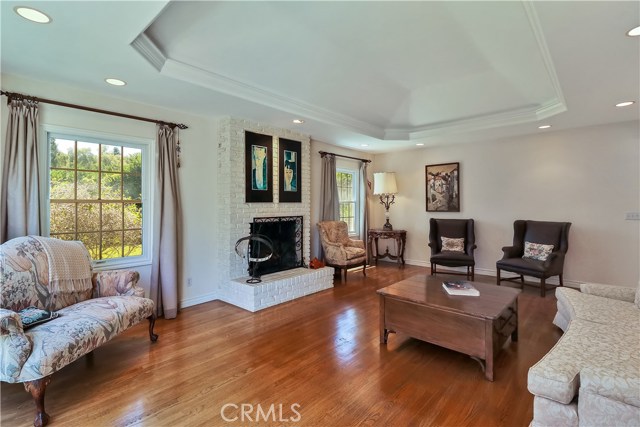 Relax in the Living Room with beautiful coved ceiling as you gaze out to the grassy backyard through a large floor to ceiling window
