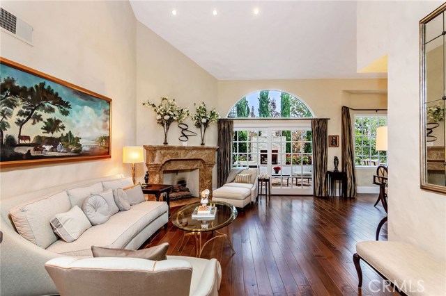 View of Living room and the beautiful french inspired sliding doors that lead to the backyard.