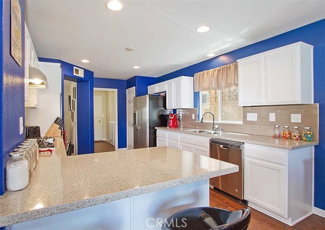 Light and bright kitchen w recessed lighting, fabulous quartz counter tops, bright white cabinets.  Pantry on the far side of refrigerator