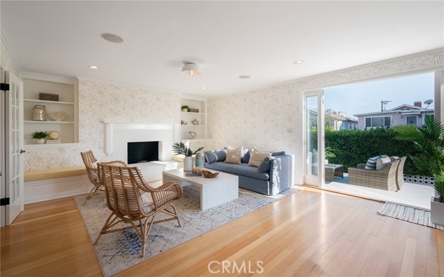 Picture perfect downstairs living room with wood floors, designer finishes and direct access to the views from the deck.