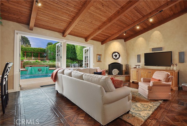 Family Room/Great Room with distinctive fireplace, opens to the pool, patio and back yards.  Note the custom parquet white oak hardwood floors.  This is the Versailles pattern with a walnut stain.