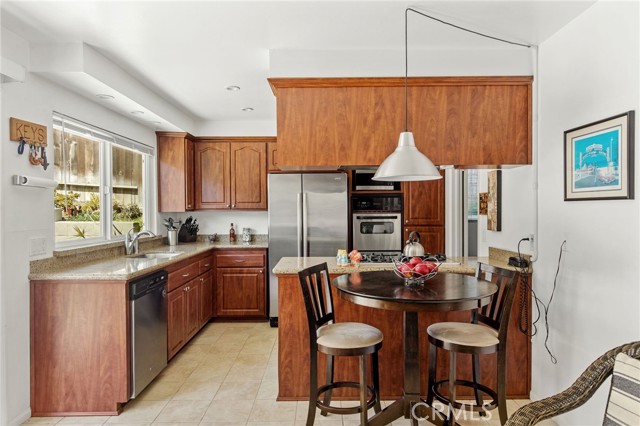 totally upgraded kitchen has quartz counters, nice cabinetry and cooktop with hood vent. All Stainless steel appliances.