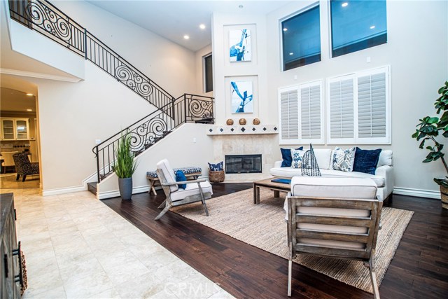 Formal living room with huge volume ceilings, tons of natural light, and a romantic fireplace!