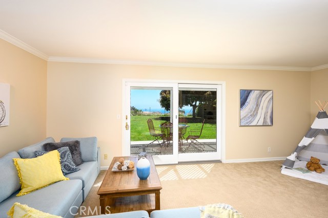 Cozy family room opens to the green lawn and ocean view beyond.