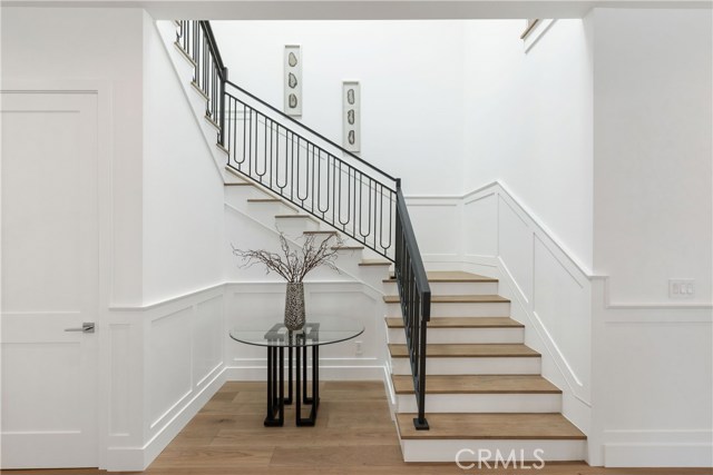 Hand crafted iron stair rails compliment the rich oak flooring and crisp white details