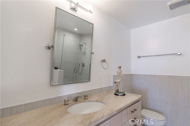 Master bath with vintage vanity, marble, chevron tiles