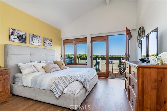 Master bedroom with french doors leading to large private deck and panoramic city/hill views.