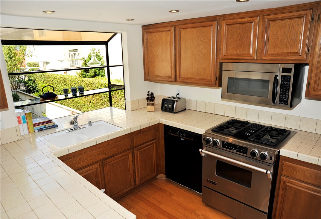 Kitchen has large garden window.