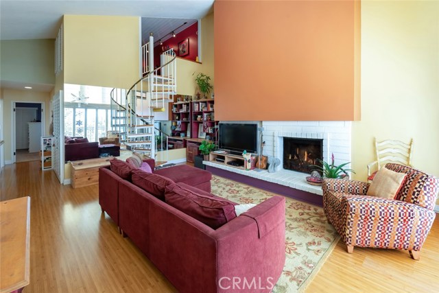 Wood burning fireplace, bamboo floors, and dramatic vaulted ceiling. Note that the spiral staircase leads up to the approx. 27'1 x 11'11 LOFT space.