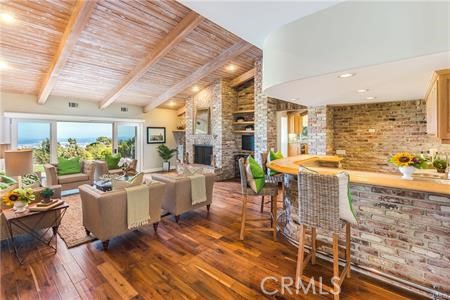 Custom farmstyle brickwork on showcase fireplace wall and bar area. Vaulted post and beam ceilings in living room and kitchen.