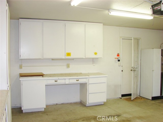 FRONT SECTION OF GARAGE WITH DIRECT HOME ACCESS AND ANOTHER GROUP OF STORAGE CUPBOARDS