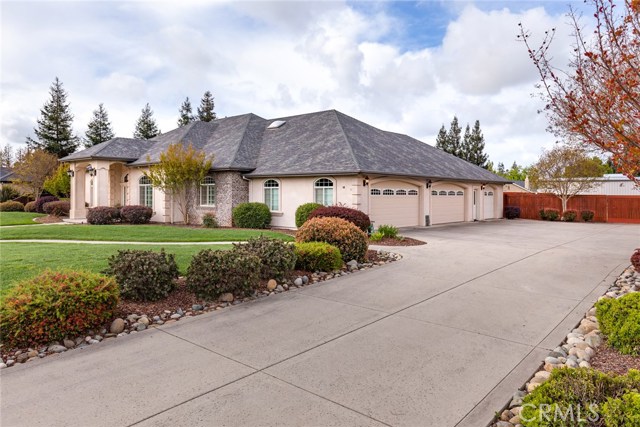 Side of home with RV parking and gate to get to the backyard area, 4 car garage (with 3rd door/golf cart garage).